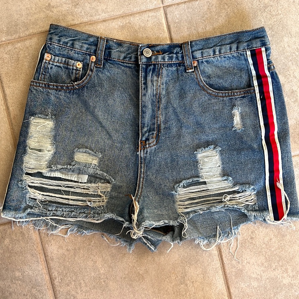 Signature8 distressed denim shorts with red white and blue stripe on both sides.